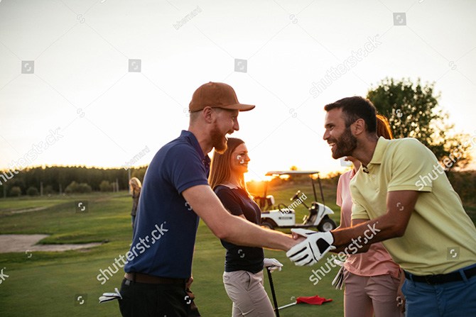 golfer shaking there hands on golf course