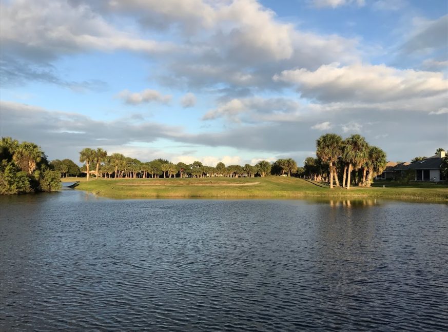 The golf course has a sizable lake and numerous trees