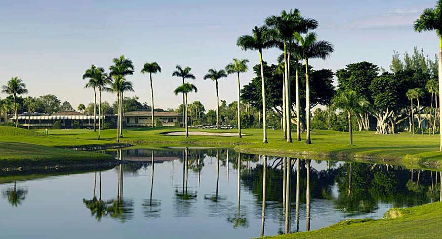 The golf course features a lake and numerous trees - Shula's Golf Club