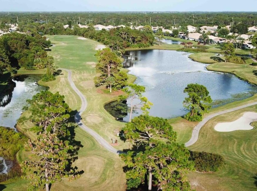 On the golf course, there is a lake and numerous homes