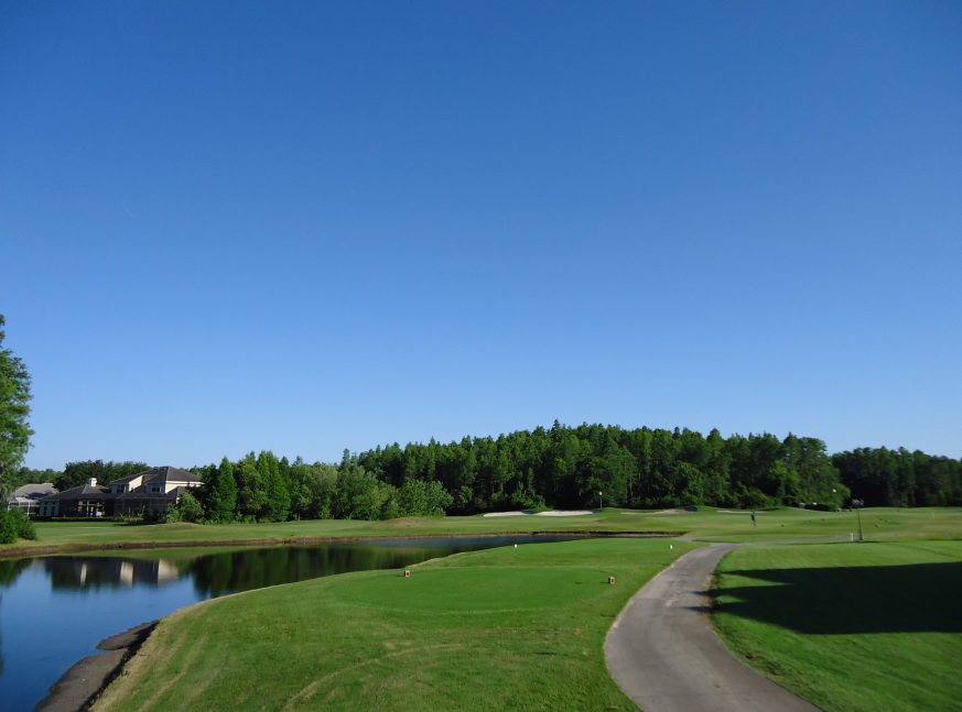 There is a golf club on the golf course, as well as a lake and many trees