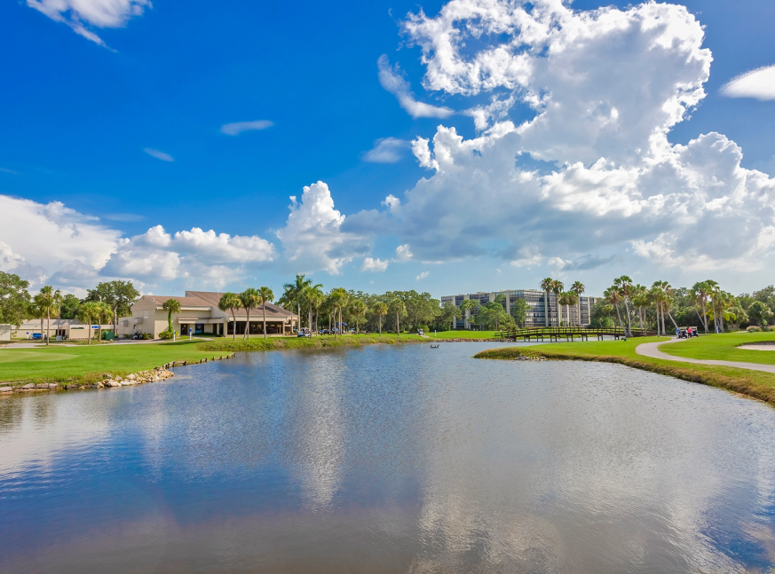 The golf course has a large lake and lot of trees trees - Cove Cay Country Club