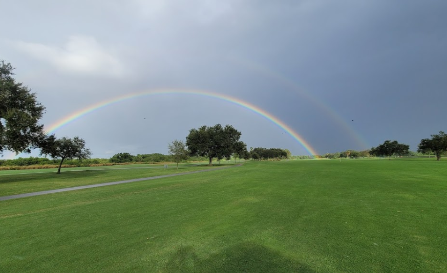 There is a rainbow view on the golf course