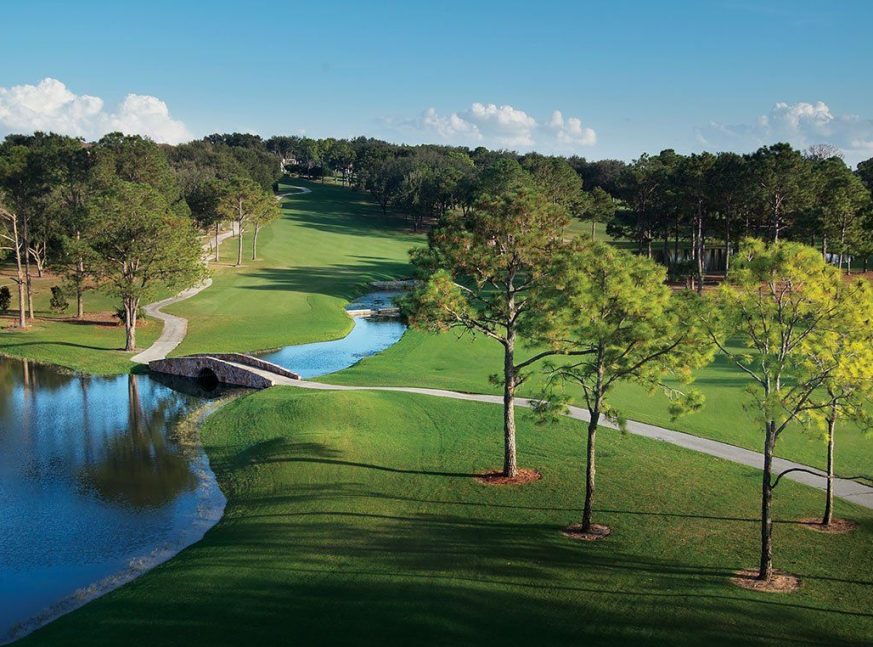 The golf course is densely forested and includes a lake