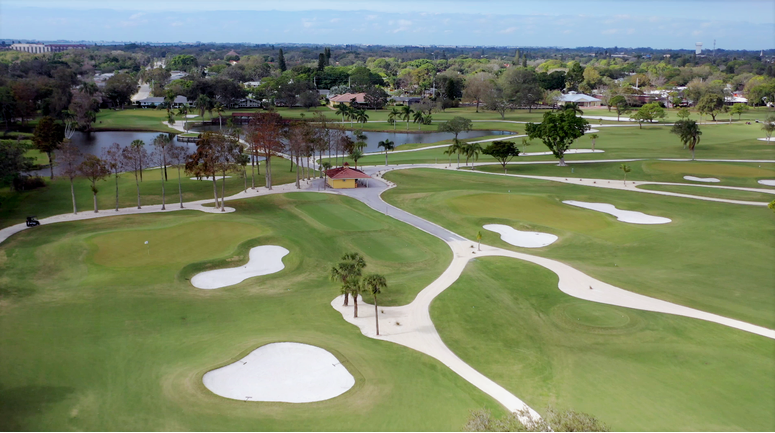 on the golf course there is a lake and a lot of homes as well a trees - Bradenton Country Club