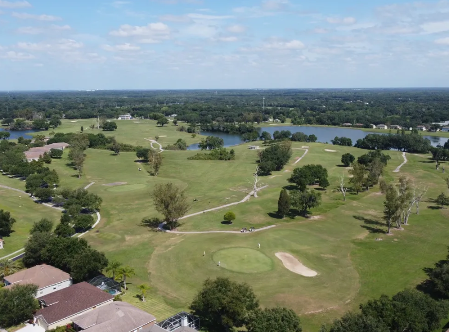 There is a river, as well as many trees and houses, on the golf course - Diamond Hill Golf Club