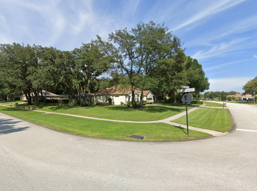 Homes surrounded by trees and street signage - Rock Springs Ridge