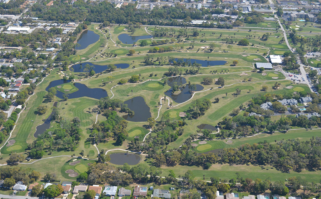 Top view of the golf course with lakes and many homes