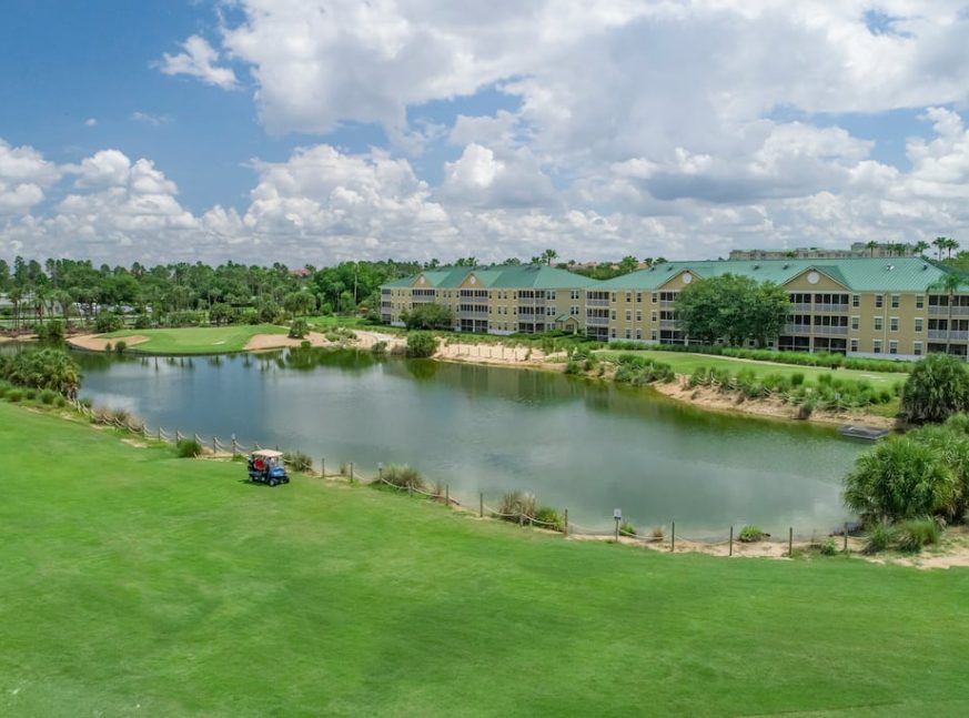 lakes, trees, clubhouses and a golf cart on the golf course - Mystic Dunes Resort and Golf Club