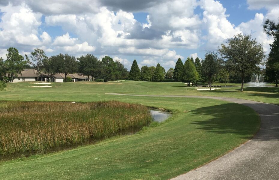 On the golf course, there is a river and a clubhouse - Lexington Oaks Golf Club