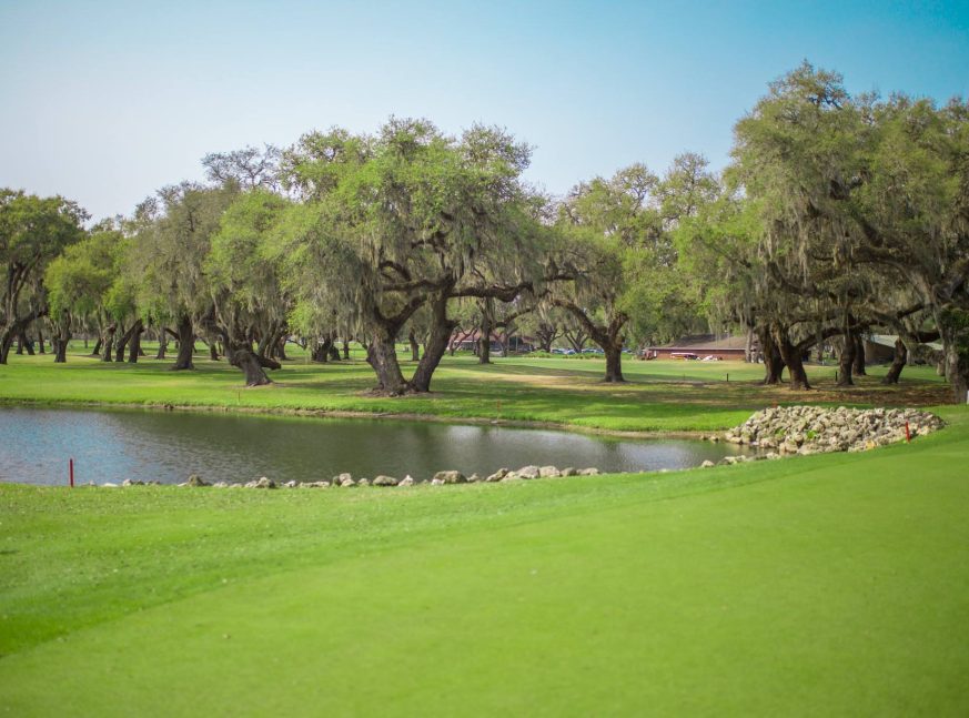 The golf course has a lake and a lot of trees - Silver Oaks
