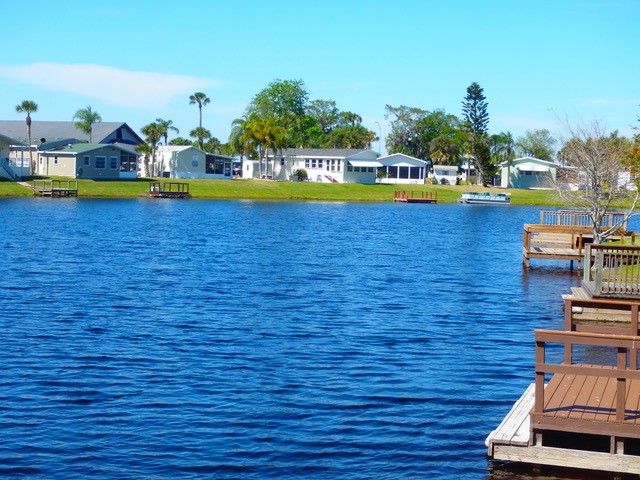 In a golf course, there are numerous clubhouse and a clean river - Blue Cypress Golf & RV Resort