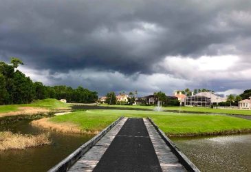 There is a bridge on the golf course's lake - alaqua country club