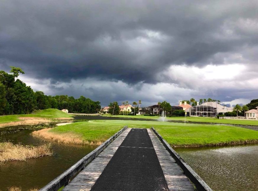 There is a bridge on the golf course's lake - alaqua country club