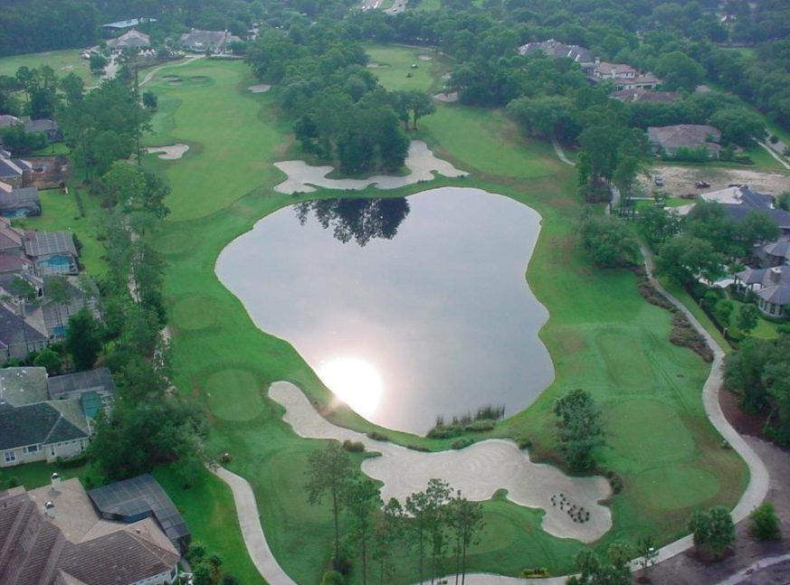 there are many lakes and house on the golf course - The Legacy Club at Alaqua Lakes