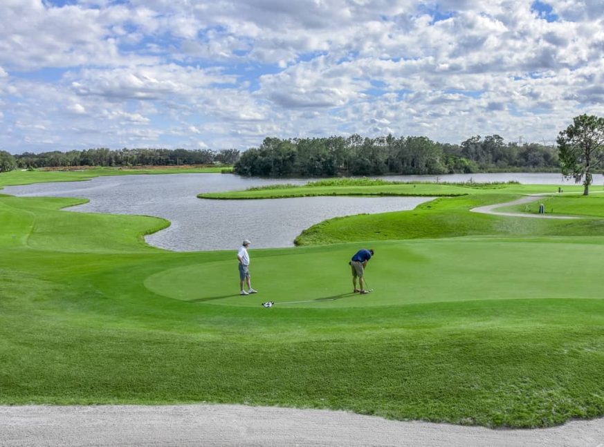 On the golf course, there is a large lake and two golfers - Fox Hollow Golf Club