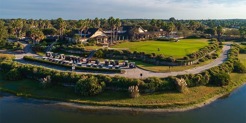 There are many golf carts and a lake at the golf club - Havana Country Club