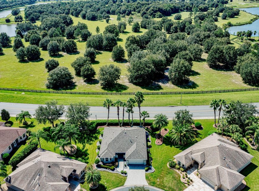 A lot of trees and homes on the golf course - The Villages of Sunset Pointe and Sunset Ridge