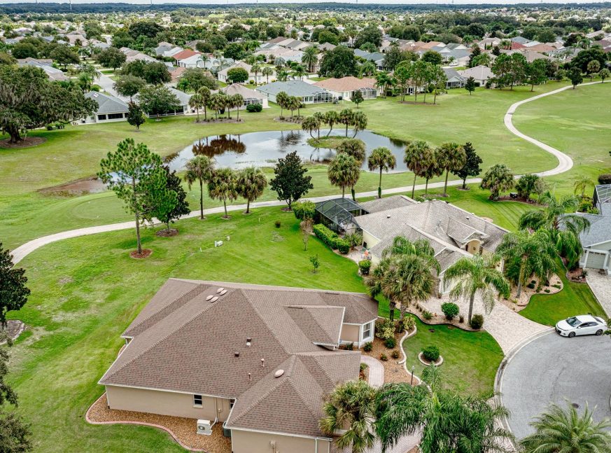 There are lake and many trees with homes on the golf course - The Villages of Lake Sumter Landing and Virginia Trace