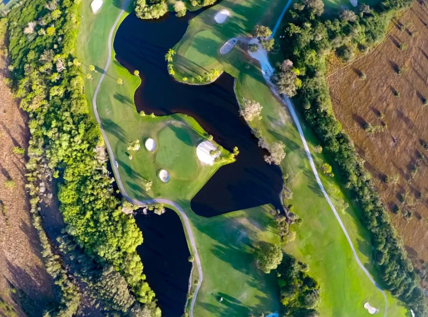 The golf course includes lakes and woods - Red/White at Myakka Pines Golf Club