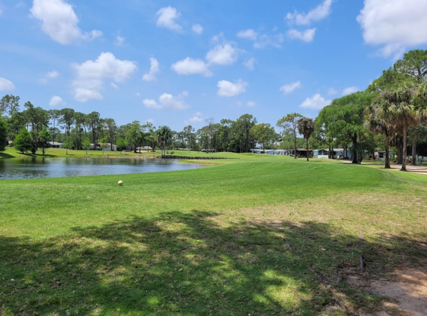Lake with homes at the back in golf course