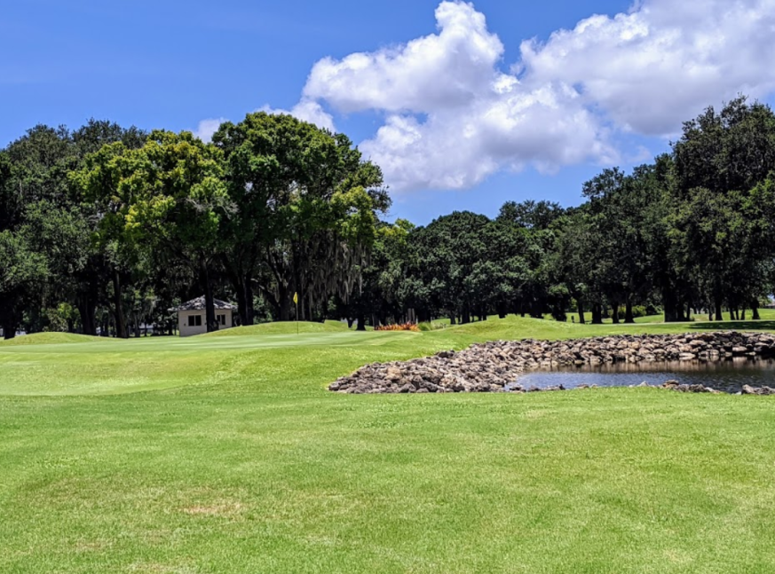 golf course with lake - Coral Oaks Golf Course
