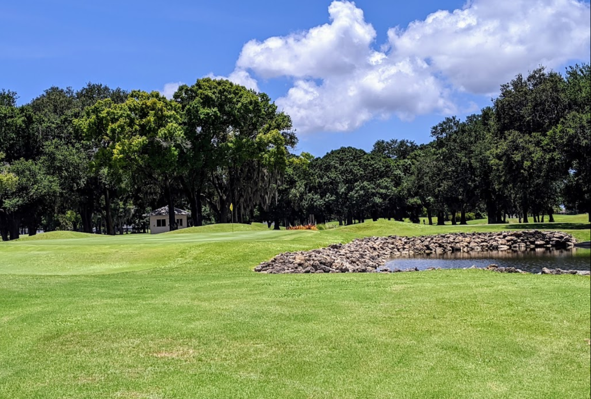golf course with lake - Coral Oaks Golf Course