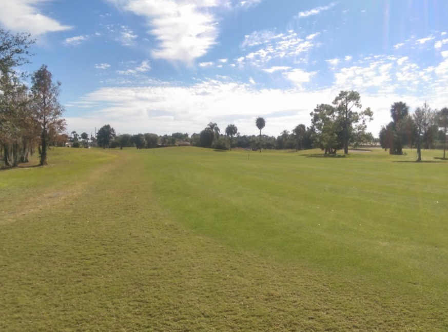 Golf course surrounded by trees - Mirror Lakes Golf Club